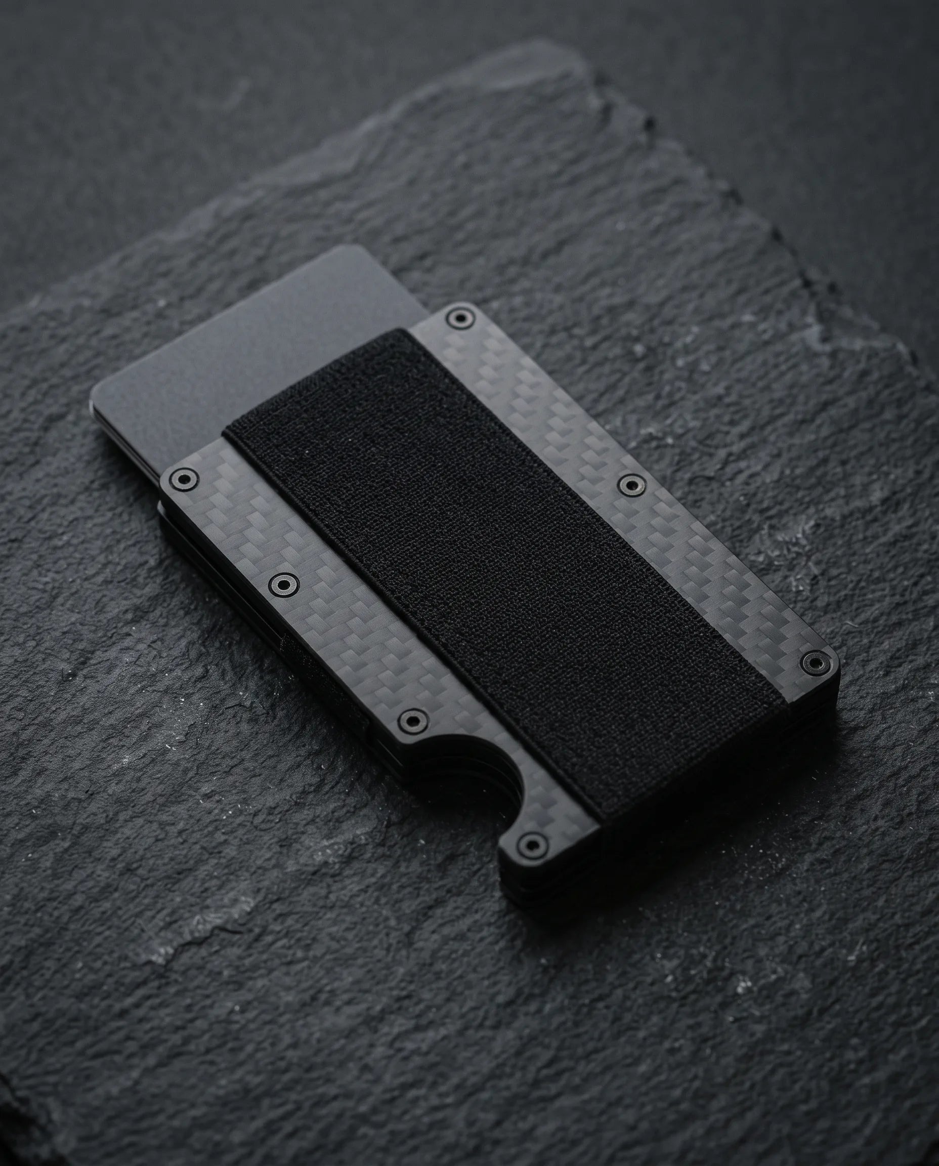 Sekage Slim carbon fiber wallet on a dark slate slab